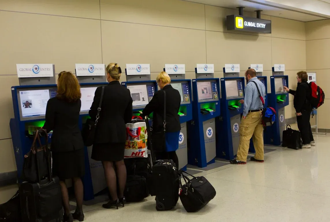 travelers check in at their kiosks.